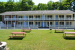 picnic tables in front of 2 story motel units