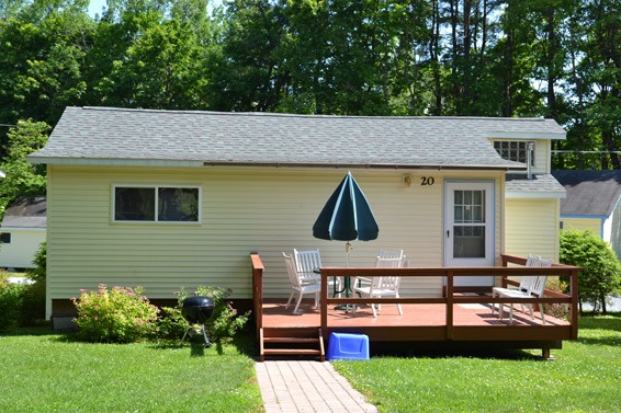 Cottage with front porch with table and chairs