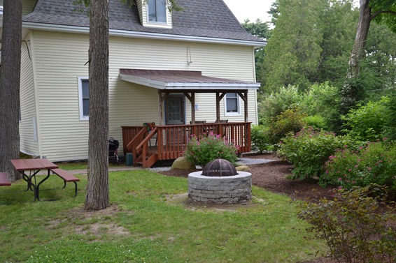 Firepit outside small deck on house